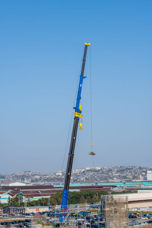 A large crane towering in a beautiful blue sky