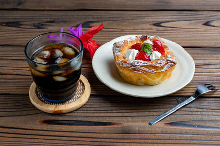 Iced coffee and strawberry Danishの写真素材