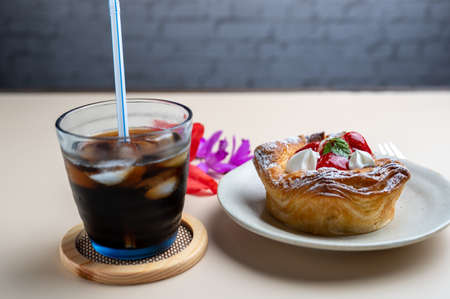 Iced coffee and strawberry Danishの写真素材