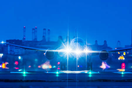 A jet flying off the beautiful runway at nightの写真素材