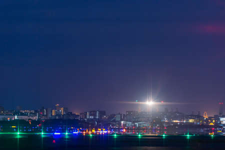 A jet flying off the beautiful runway at nightの写真素材