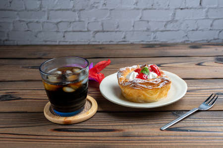 Iced coffee and strawberry Danishの写真素材