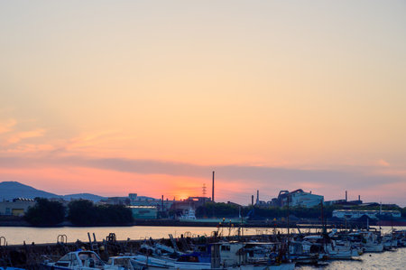 Beautiful sunset and factory view at sunset over Kitakyushu Industrial Areaの写真素材