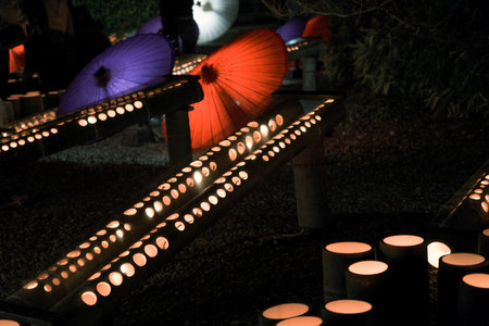 It is a winter light festival that was held on February 11, 2023 in Yamaga City, Kumamoto Prefecture, Japan, where Japanese umbrellas and bamboo lanterns were lit up at night.の写真素材
