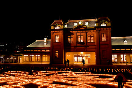 UA beautiful view of Mojiko Station at night with candles decorating the square in front of it.のeditorial素材