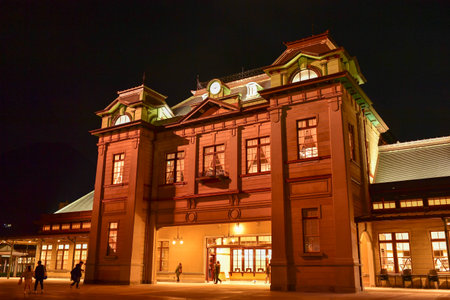 A beautiful view of Mojiko Station at night with candles decorating the square in front of it.のeditorial素材