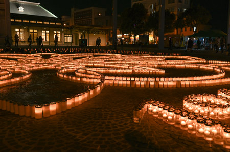 A beautiful view of Mojiko Station at night with candles decorating the square in front of it.のeditorial素材
