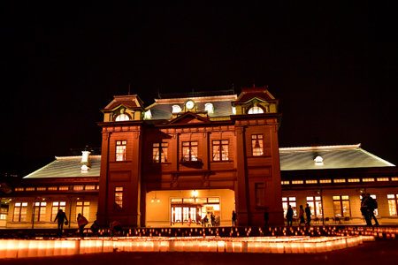 A beautiful view of Mojiko Station at night with candles decorating the square in front of it.のeditorial素材