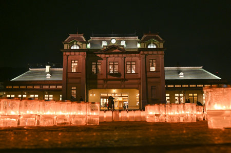 A beautiful view of Mojiko Station at night with candles decorating the square in front of it.のeditorial素材
