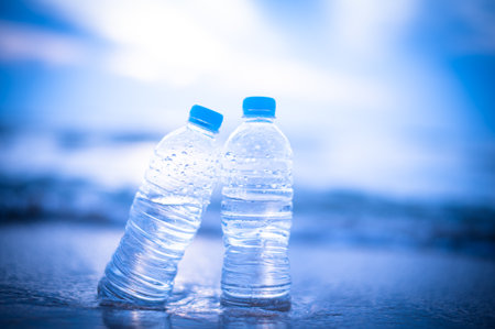 Plastic bottle with water on the beach, soft focus background.の写真素材