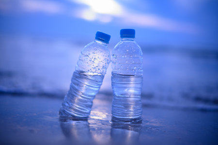 Bottle of water on the beach with blue sky and sea background.の写真素材