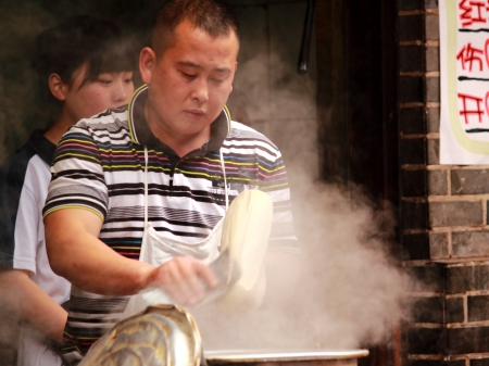 Chengdu China - May 03,2012,Experienced noodle master cooking noodles in Luodai village Chengdu Chinaのeditorial素材