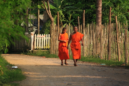 Luang Prabang Laos - May 14,2012,Lao monks walking down the quiet street in Luang Prabang Laos のeditorial素材