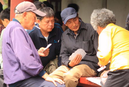 Beijing China - May 12,2012, People enjoying card games at Temple of Heaven Beijing China のeditorial素材