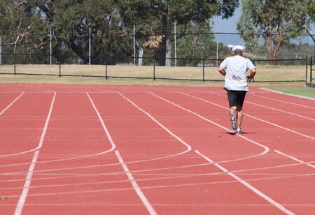 MELBOURNE AUSTRALIA - FEBRUARY 1, 2014  Unidentified man jogs in local track  のeditorial素材