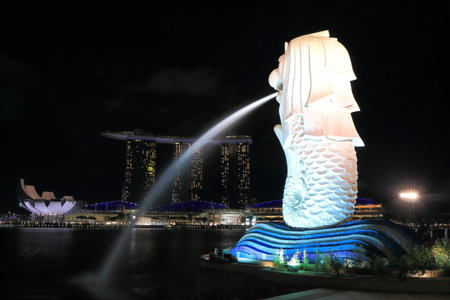 Singapore, Singapore - 27 May, 2014 Merlion and contemporary Marina Bay Sands complex by night in Singapore  のeditorial素材