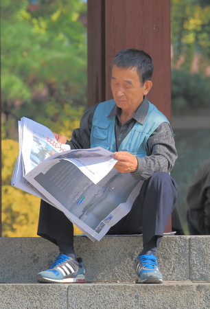 Seoul South Korea - October 20, 2016: Unidentified people read newspapers in Tapgol park.のeditorial素材