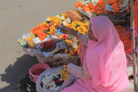 Udaipur India - October 15, 2017: Unidentified woman sells flower offering at Jogdish temple Udaipur India.のeditorial素材