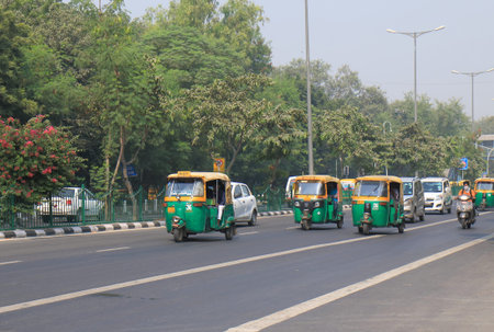 New Delhi India - October 28, 2017: Tuk tuk motorbike taxis take passengers in downtown New Delhi...