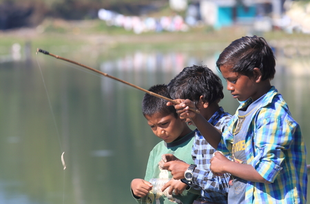 Pokara Nepal - November 8, 2017: People fish at Dam Side Park in Pokara Nepal.のeditorial素材