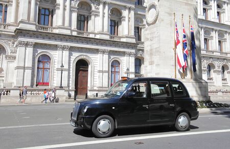 London England - June 1, 2019: Taxi black cab drive through downtown London UKのeditorial素材
