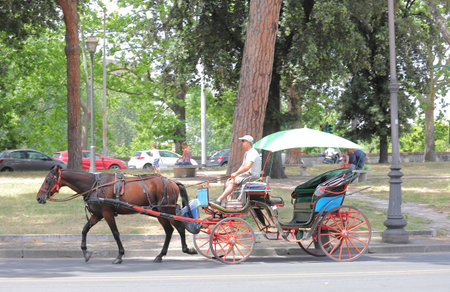 Rome Italy - June 15, 2019: People ride horse carriage for tourist in Rome
