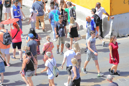 Rome Italy - June 17, 2019: People walk pass street touts in Colosseum Rome Italy