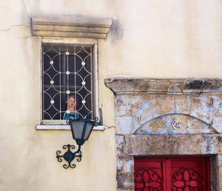 Fragment of vintage facade with dolls decorated window, lantern and doors. Tel Aviv, Israel.の写真素材