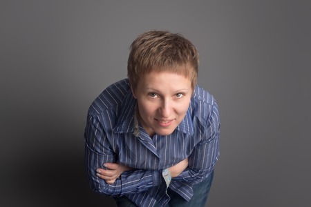 Happy smiling middle-aged woman in blue shirtの写真素材