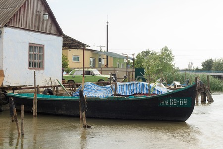 Vilkovo, Ukraine - May, 26, 2018: A channel along the street, and fishing boatsのeditorial素材