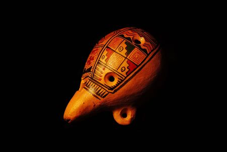 Traditional clay painted ocarina on black backgroundの写真素材