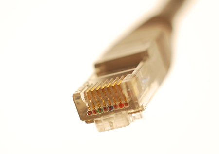 Close shot or a RJ-45 network connector on white background. 