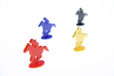 horse race with red horse winner isolated on white. toy plastic gameの写真素材