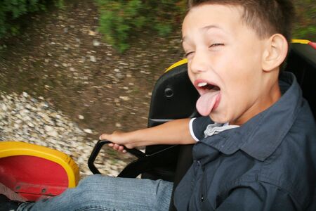 roller coaster ride. child screaming with joy in amusement park rideの写真素材
