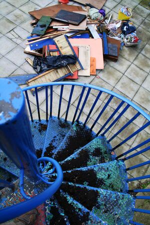 staircase in blue and rubbish dump. iron ladder lead downの写真素材
