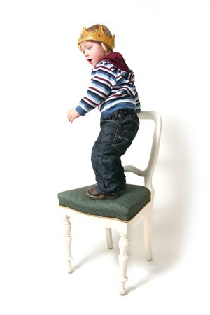 Child is king. toddler with crown isolated on white symbol for rulerの写真素材