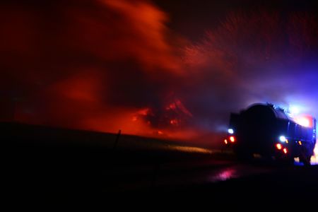 house on fire at night. blaze of flames burn down farm の写真素材