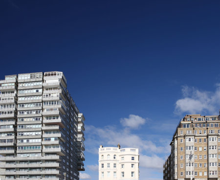 tower block modern and classic against blue sky. offices, flats or apartments from three different...