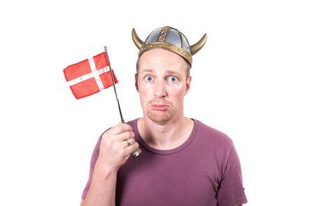 man with viking helmet and danish flag looking sad. Scandinavian middle age male isolated on whiteの写真素材