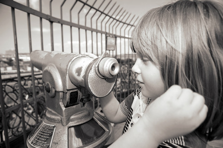Sightseeing lookout binoculars with view of copenhagen. child tourist use telescope to see capital of denmarkの写真素材