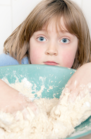 bread making with child kneading dough. cooking pastery product at homeの写真素材