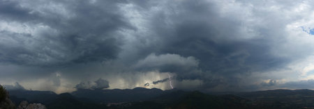 Approaching thunderstorm with lightning strike in the mountains of the South of France, near the...