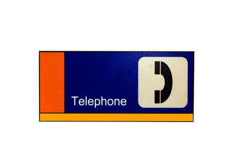 blue phone label at wallの写真素材