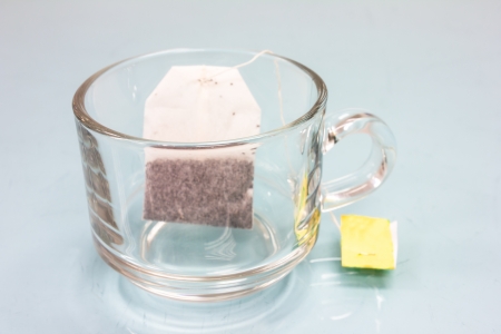 tea bag in cup on glass tableの写真素材