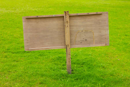 wood label sign in green grassの写真素材