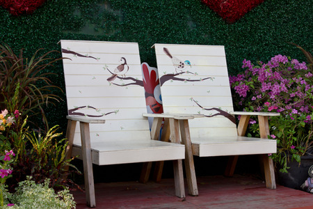 flower on table and chairs at a backyardの写真素材