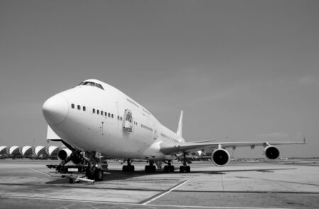 black and white Airplane near the terminal in an airport cockpitの写真素材