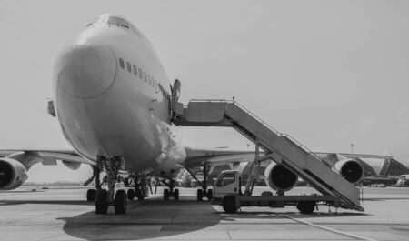 black and white Airplane near the terminal in an airport cockpitの写真素材