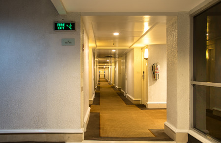 Emergency fire exit sign and corridor in the hotelのeditorial素材