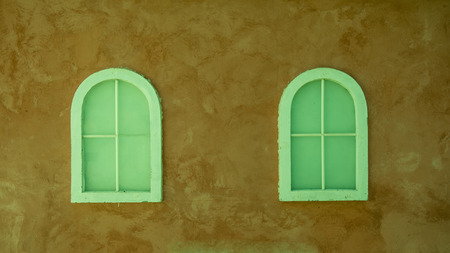 Vintage window on nice color cement wall can be used for background, vintage color styleの写真素材